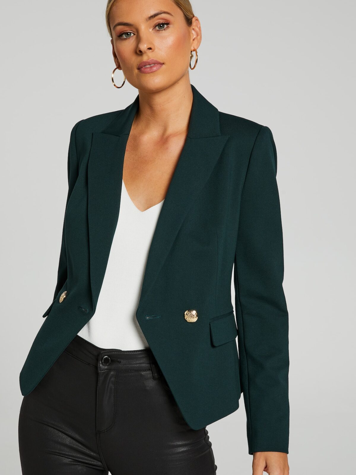 Model wears dark green Willow blazer from Portmans