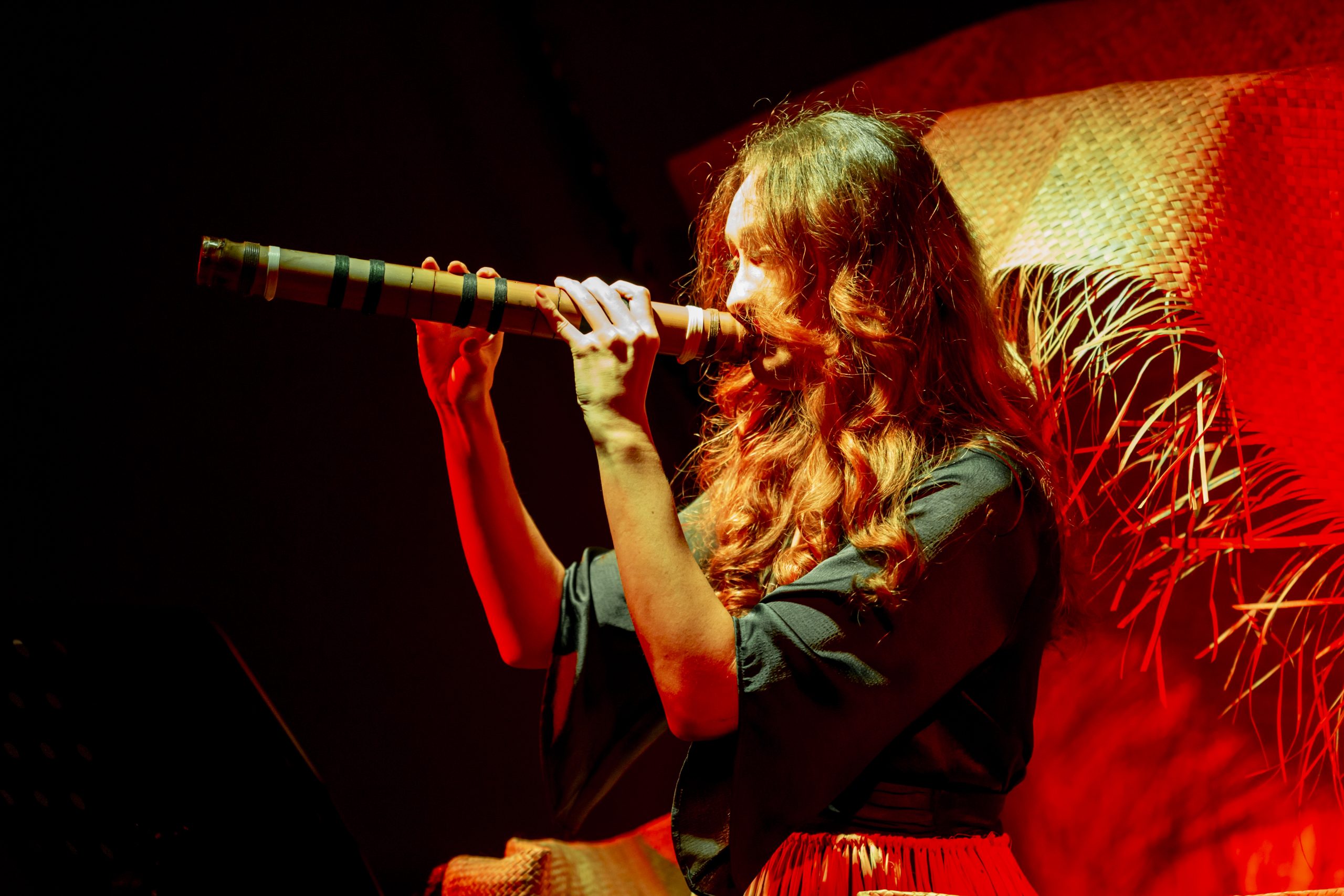 Adriana Māhanga Lear, Tu'uloa—In standing, to endure, 2024, performance with fangufangu (bamboo nose-flute), Casula Powerhouse Arts Centre. Photo: Chantel Bann.